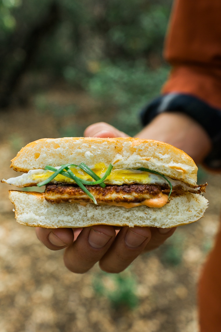 michael holding a Grilled Halloumi Breakfast Sandwich