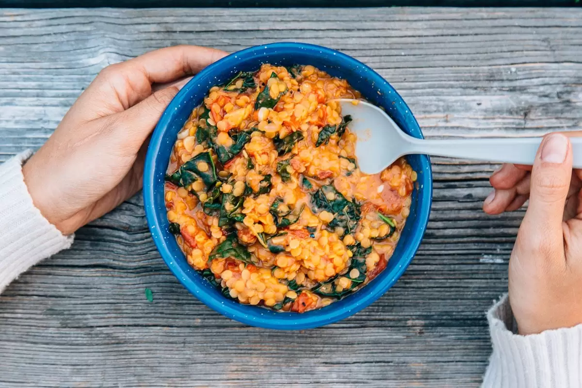 Coconut red lentil stew in a camping bowl