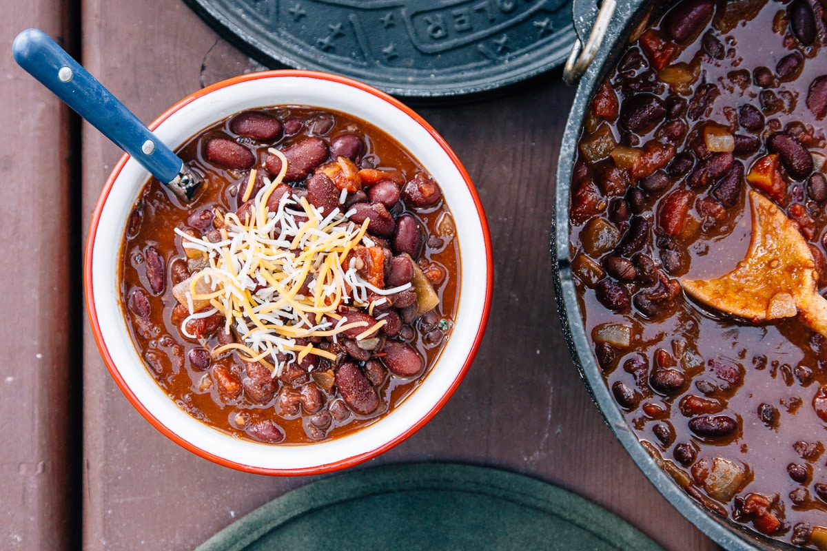 Chili in a bowl next to a Dutch oven