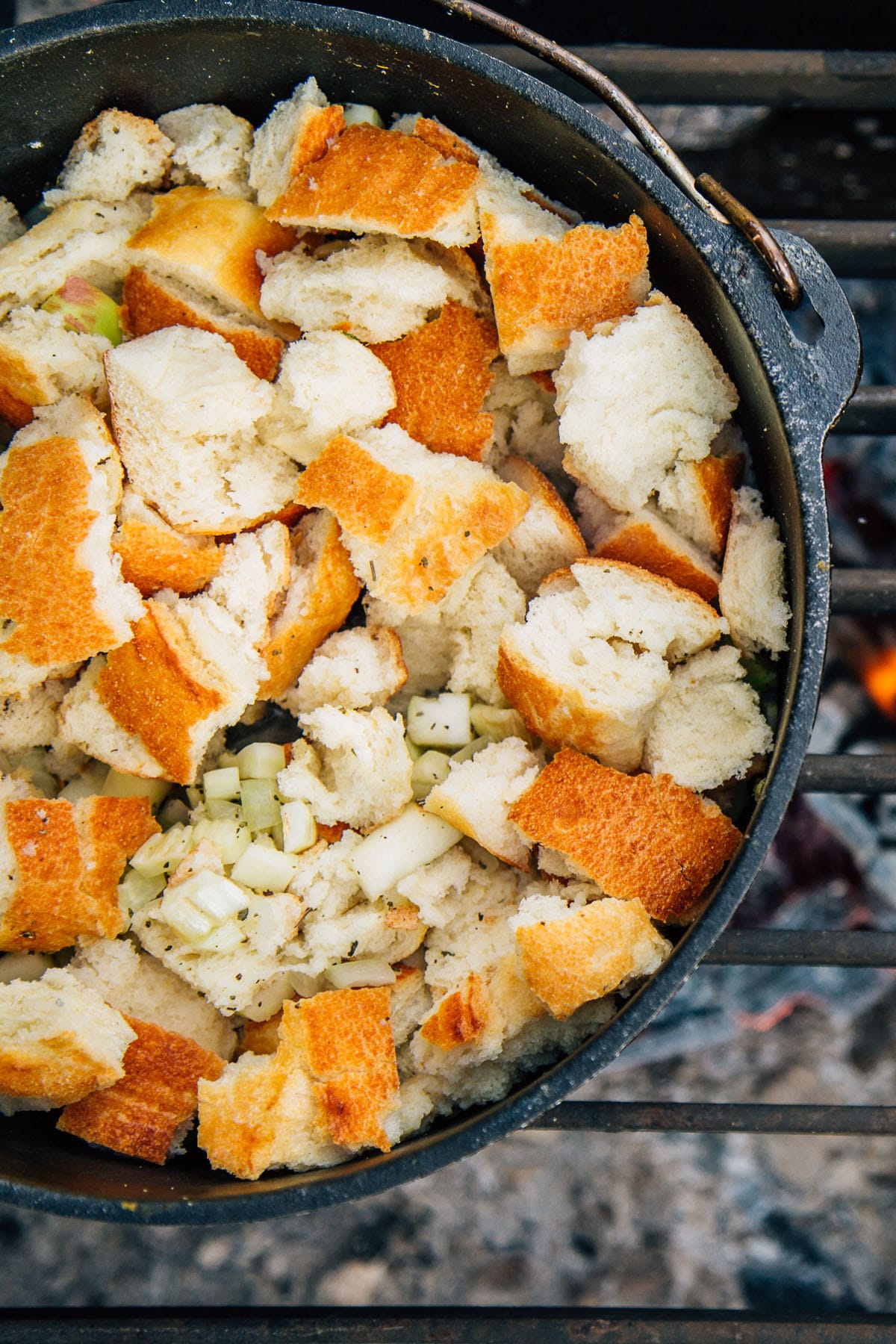 Stuffing in a Dutch oven over a campfire