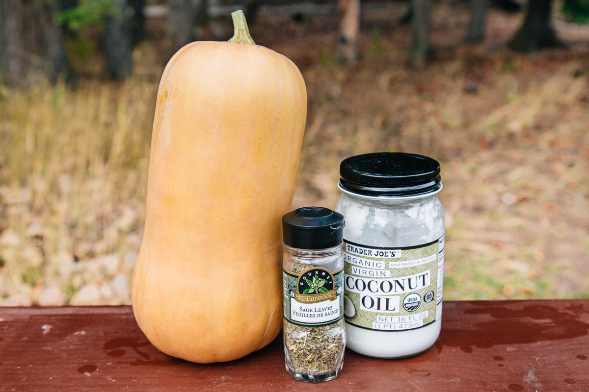 A butternut squash next two jars of oil and spices
