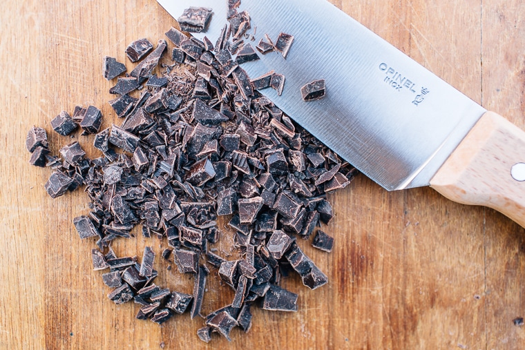 Chopped chocolate on a wooden cutting board