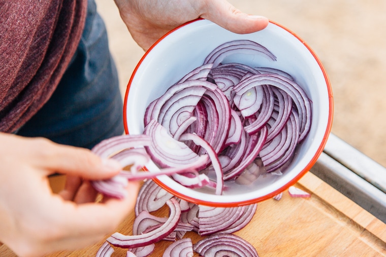 Megan with a bowl sliced red onions