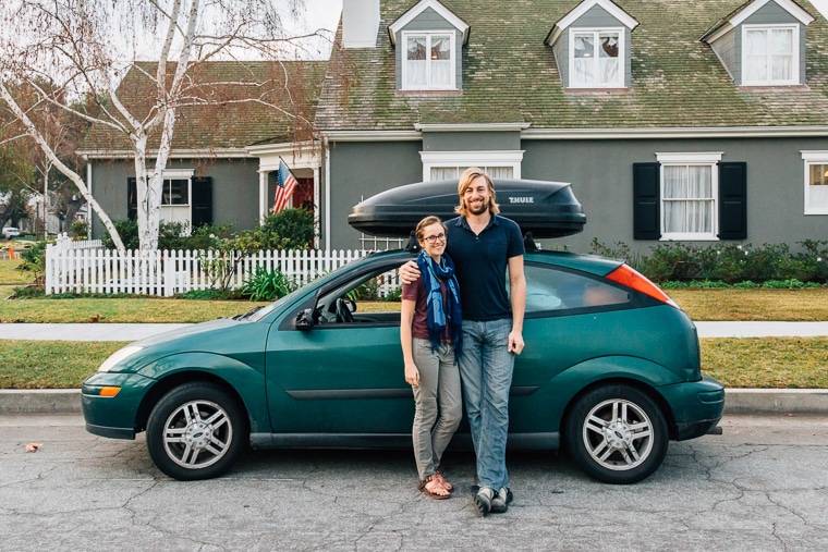 Megan and Michael standing in front of their green car