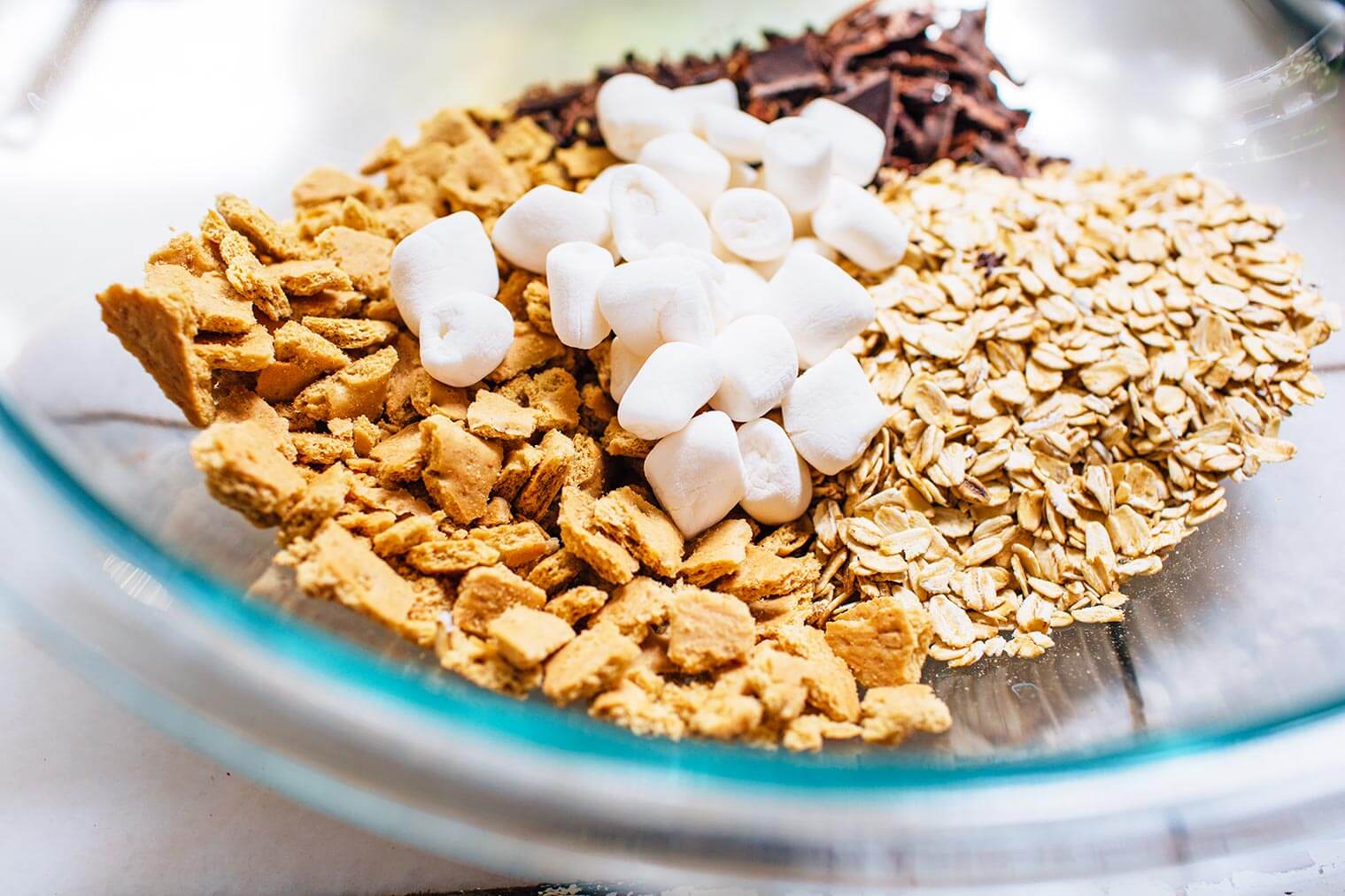 Marshmallows crumbled graham crackers oats and chocolate in a bowl