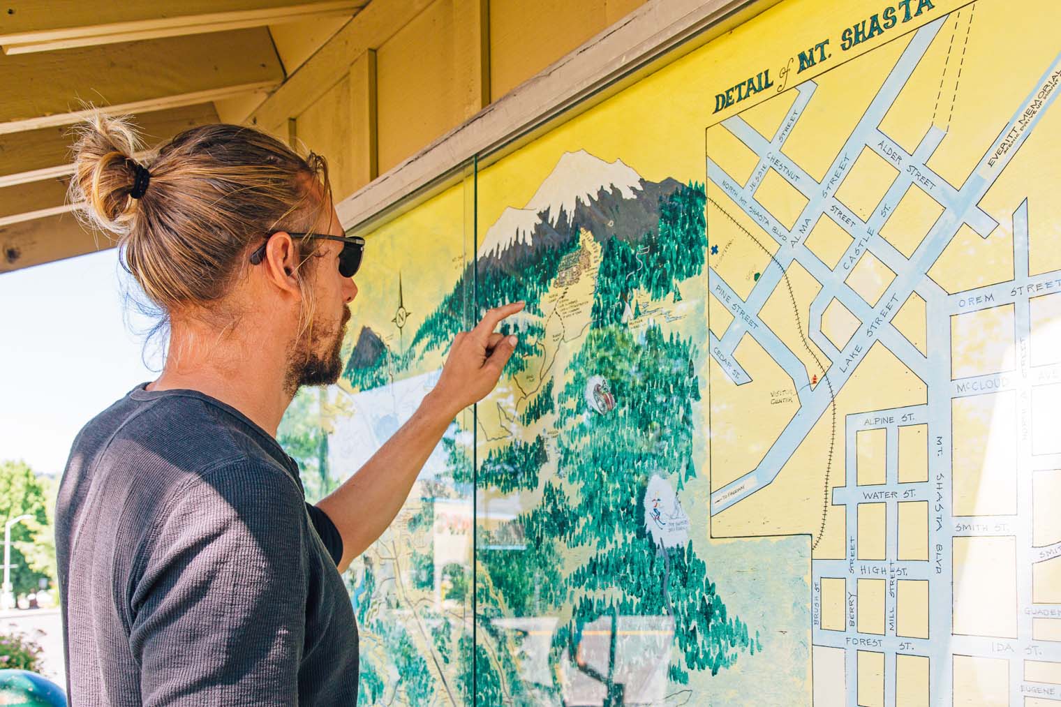 Michael looking at a painted map of Mount Shasta