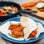 Grilled sweet potatoes and vegetables in a flour tortilla