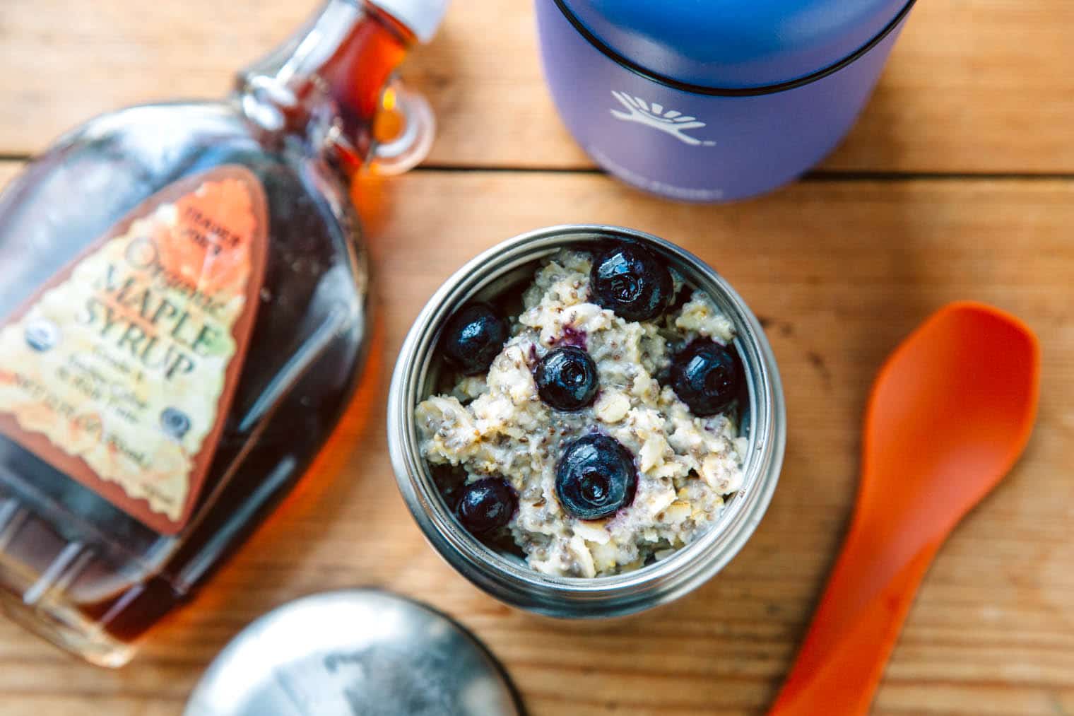 Oatmeal topped with blueberries inside a insulated food jar