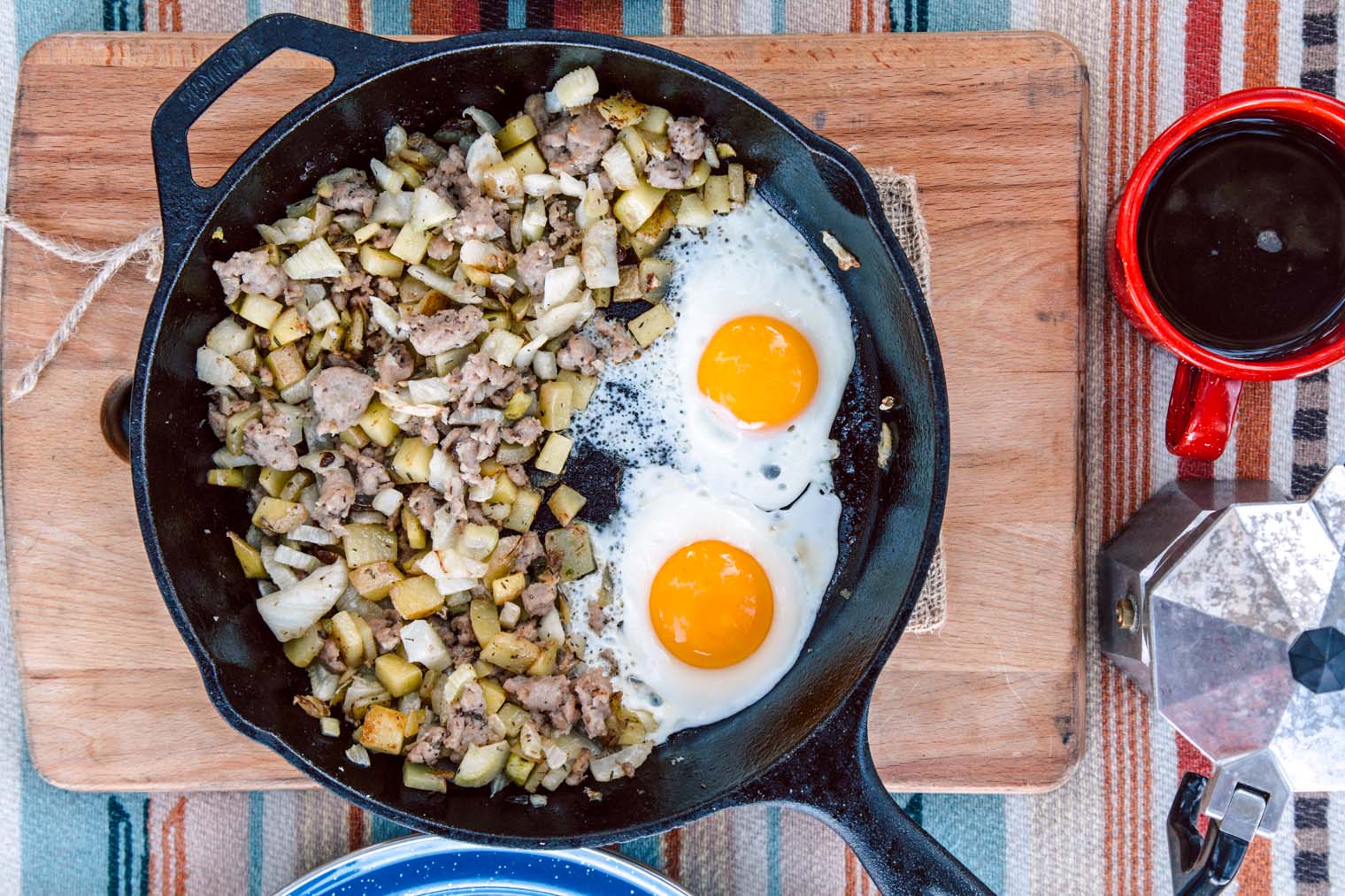 Sausage and fennel hash with two eggs in a cast iron skillet