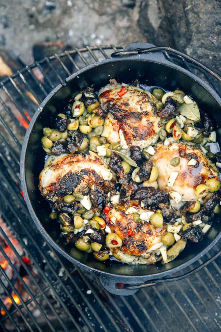 Chicken Marbella in a Dutch oven over the campfire