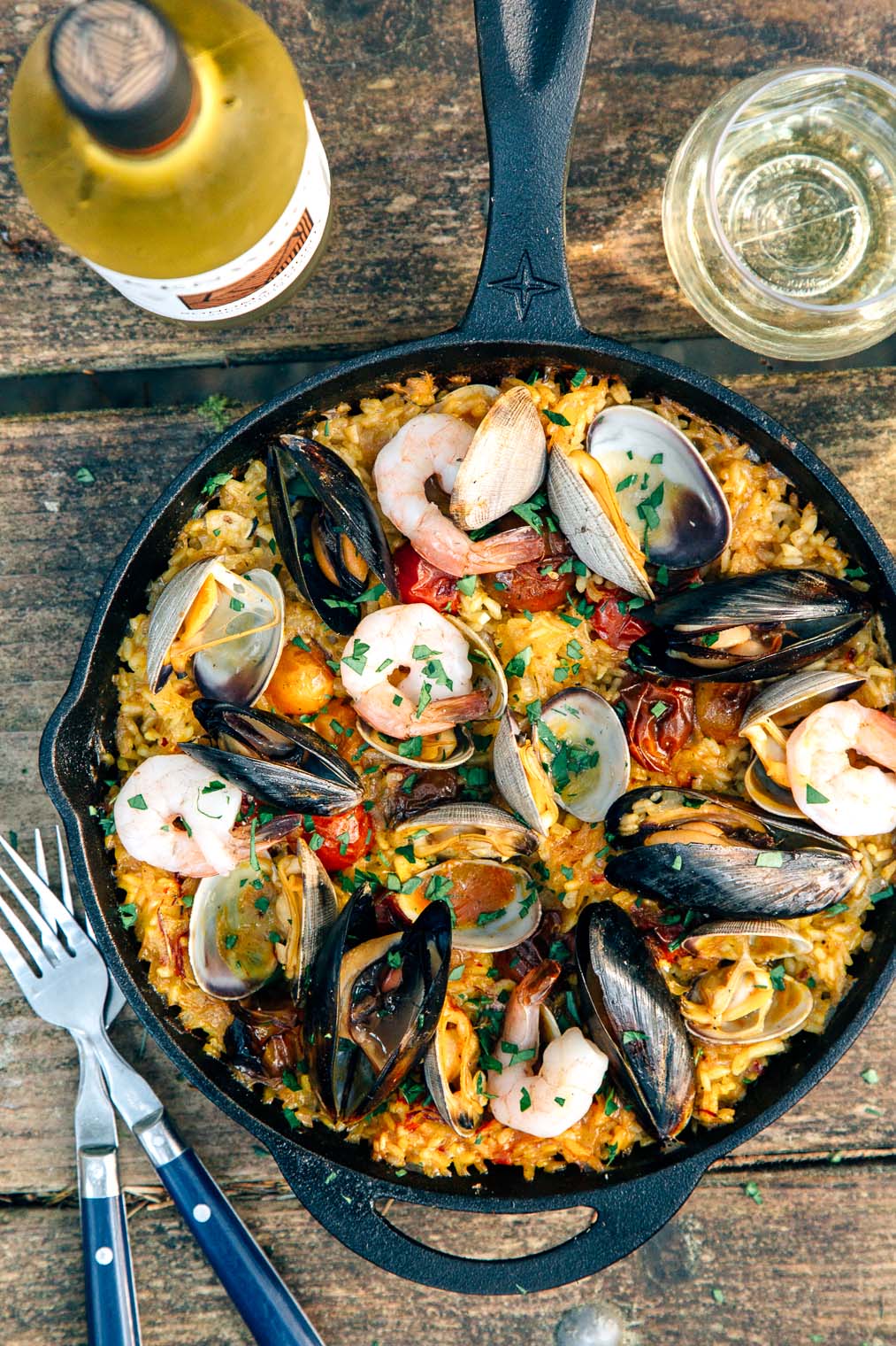 Paella in a cast iron skillet on a camp table