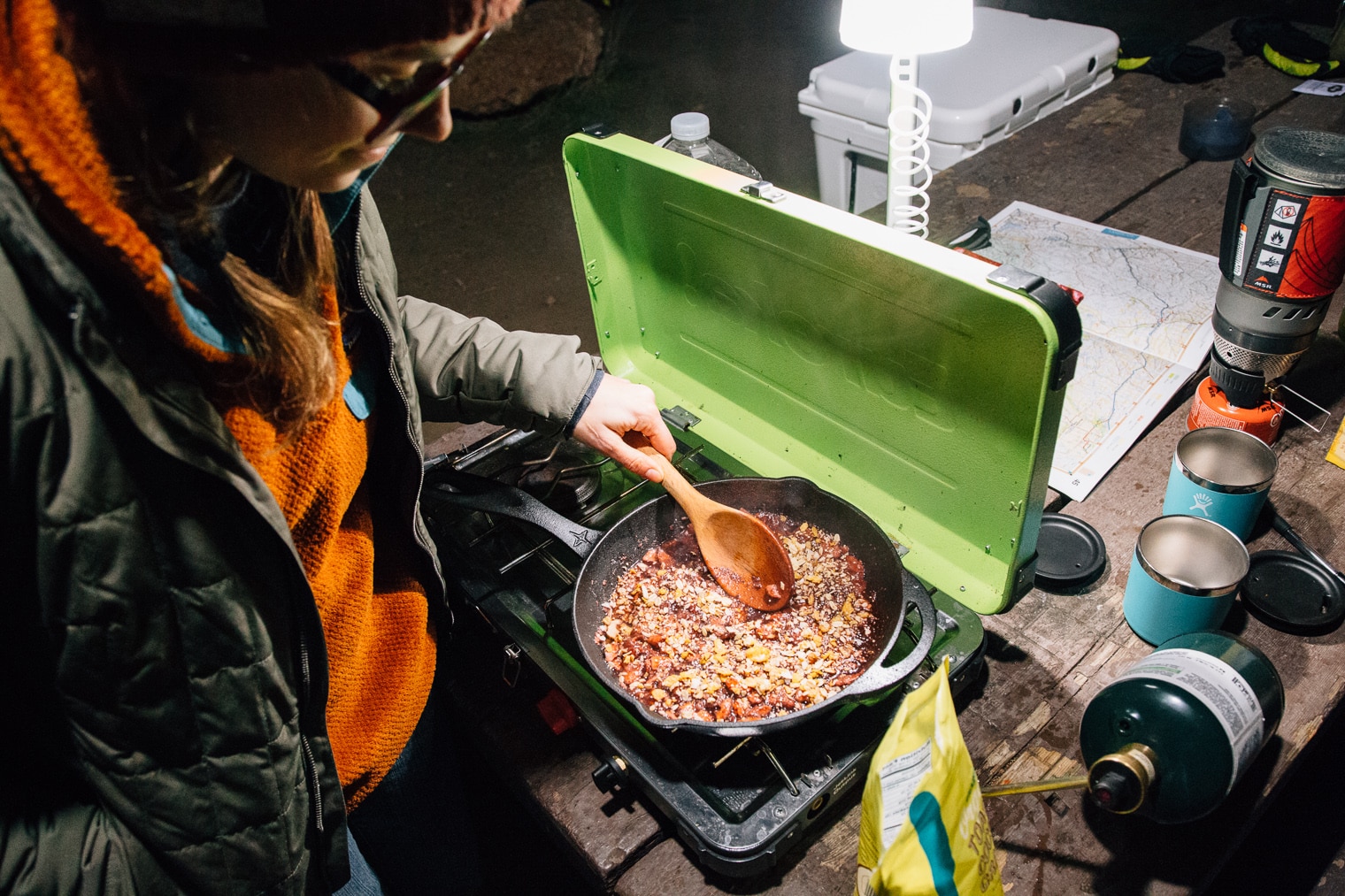 Megan cooking desert on a camp stove