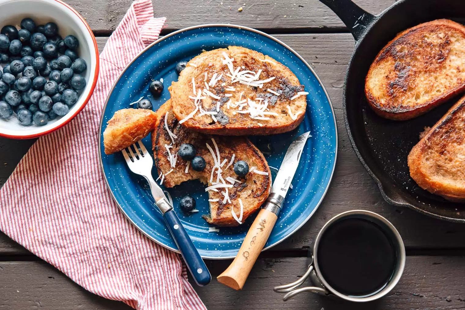 Three pieces of French toast on a blue enamel plate