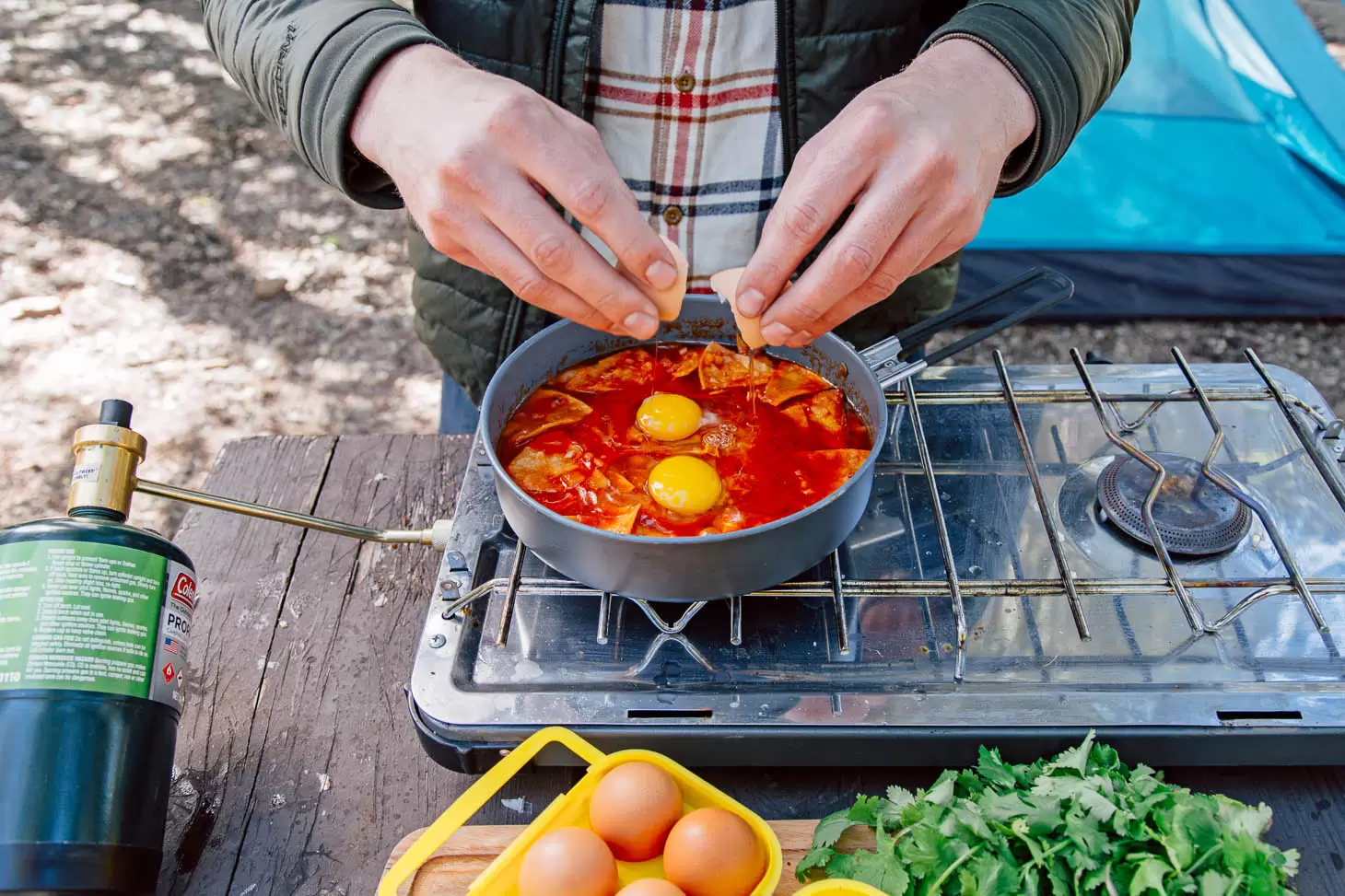 Chilaquiles is an easy camping breakfast idea - crispy tortillas simmered in a spicy tomato sauce and topped with eggs. It takes less than 30 minutes to make, and it's vegetarian, too!