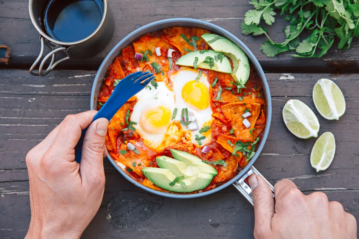 Chilaquiles is an easy camping breakfast idea - crispy tortillas simmered in a spicy tomato sauce and topped with eggs. It takes less than 30 minutes to make, and it's vegetarian, too!
