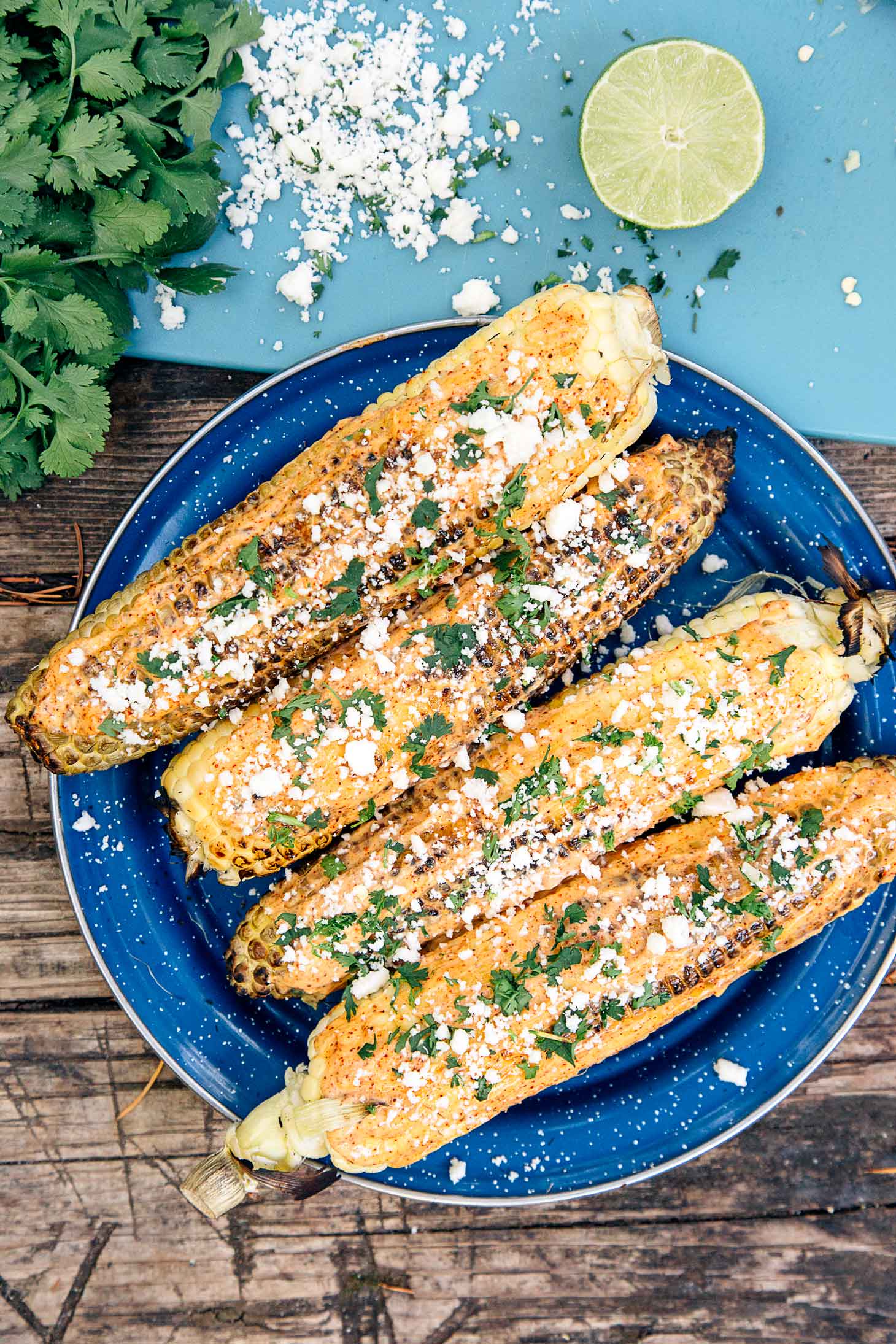 Elotes - grilled Mexican street corn - are a great appetizer to cook over the campfire!