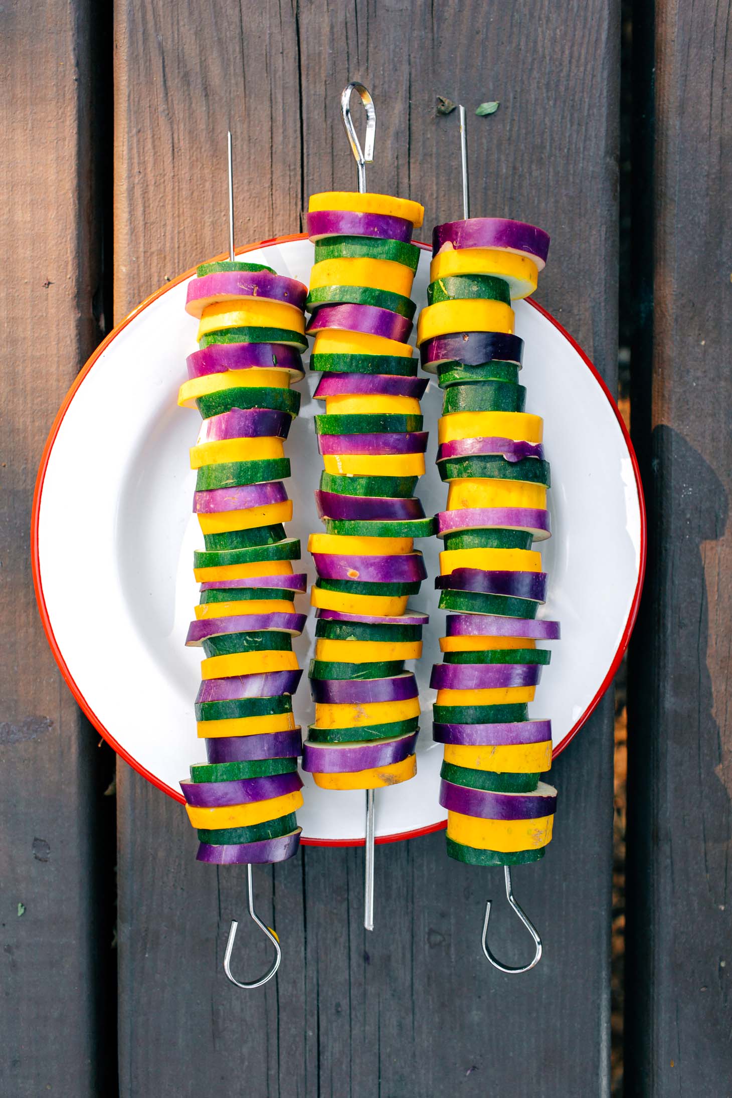 Three colorful vegetable kebabs on a plate