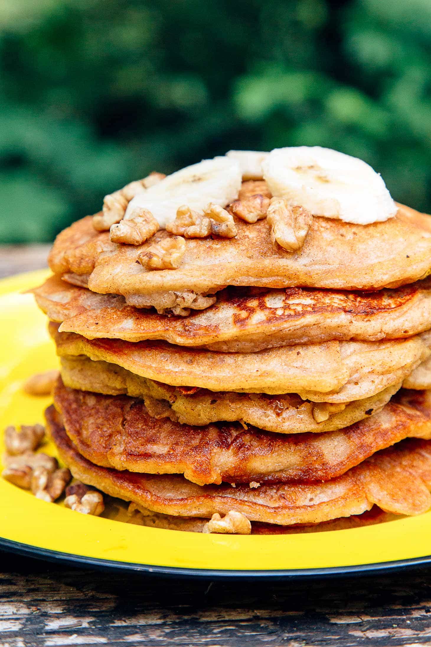 Banana Bread Pancakes stacked on a yellow plate.
