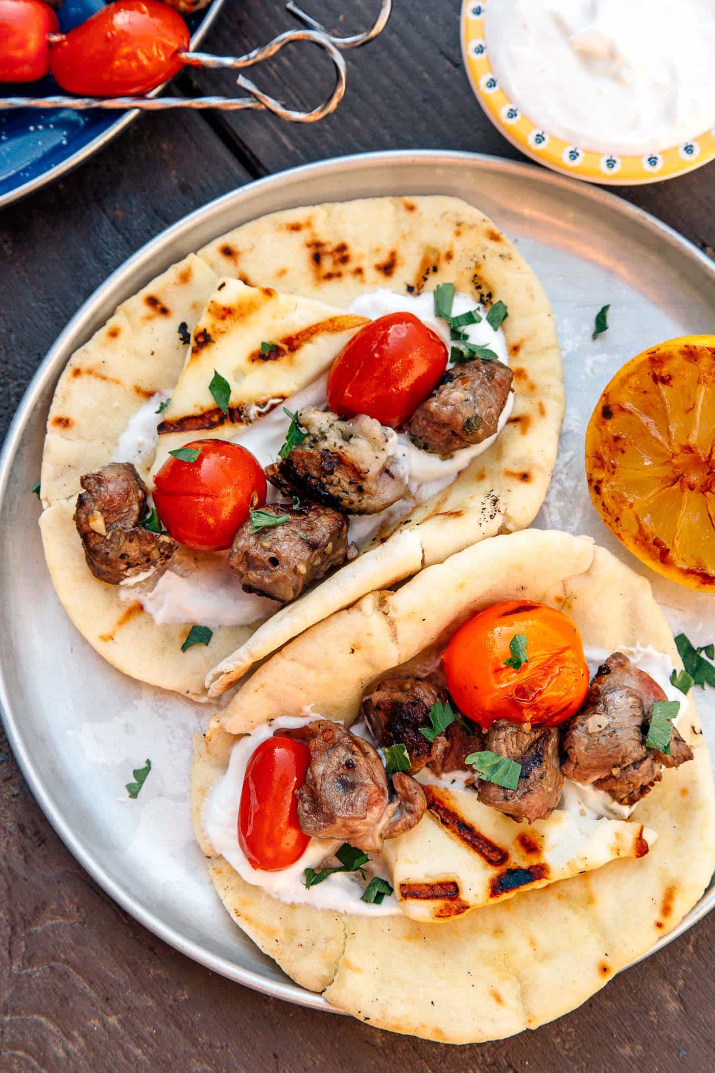 Grilled Gyros Kebabs on a silver camping plate.