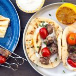 Grilled Gyros Kebabs on a silver camping plate.