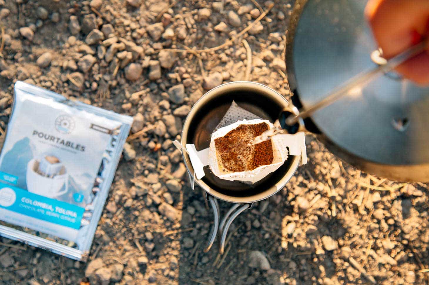 Pouring water into a camping coffee pour over