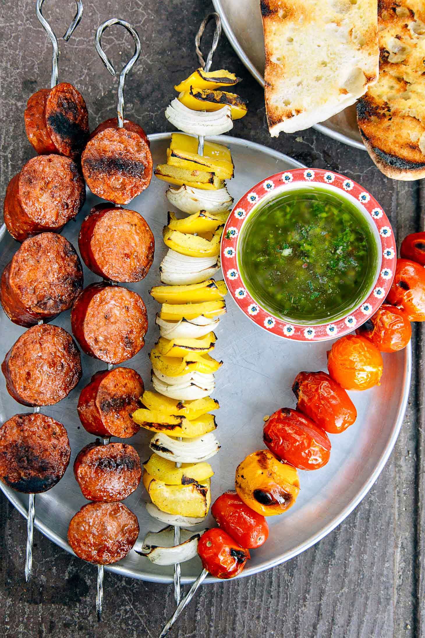 Grilled Chorizo Kebabs on a silver camping plate.