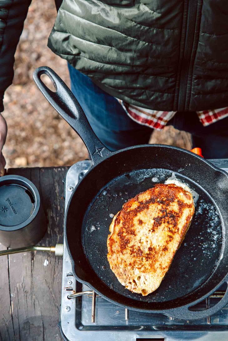 French Toast in a cast iron skillet on a camping stove.