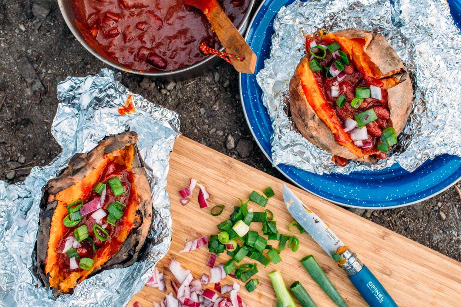 A hearty meal perfect for fall camping trips, this chili stuffed baked sweet potato recipe is easy to make around the campfire.