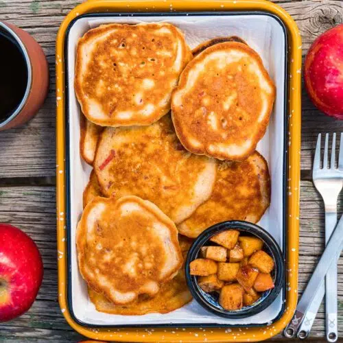 A serving dish loaded with apple pancakes.