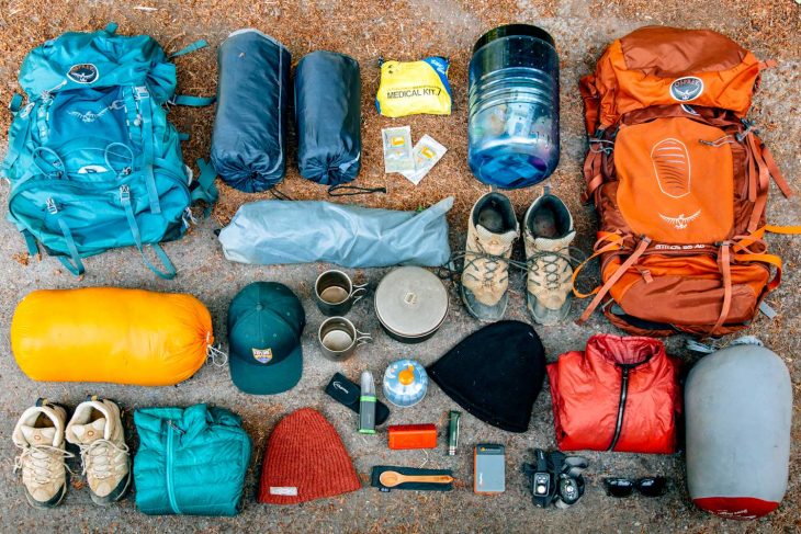 Overhead view of backpacking gear laid out on the floor.