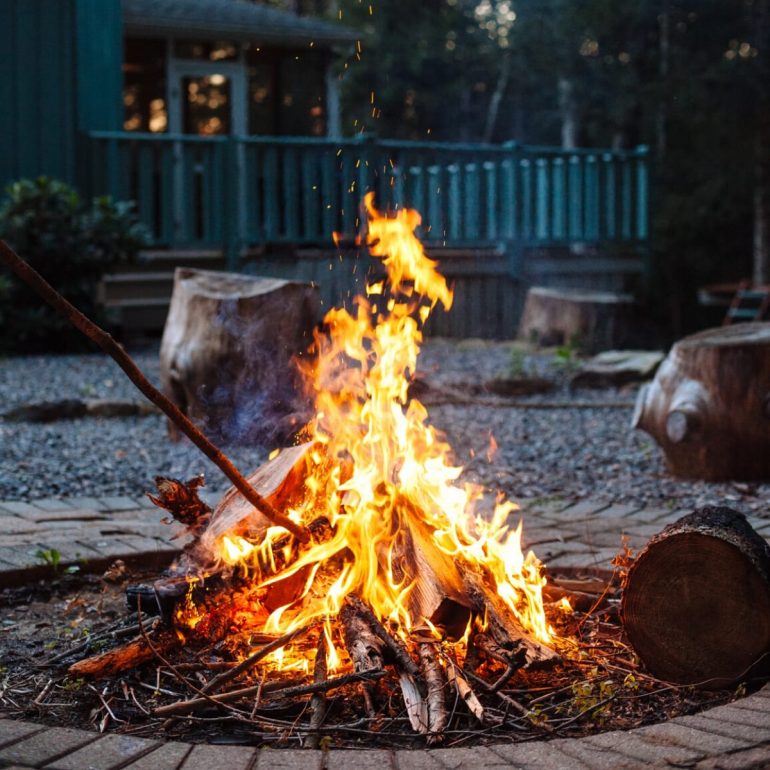 A bonfire with a house in the background