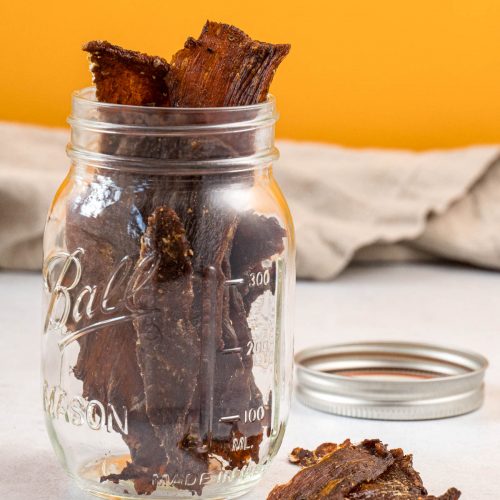 Homemade beef jerky in a mason jar for storage
