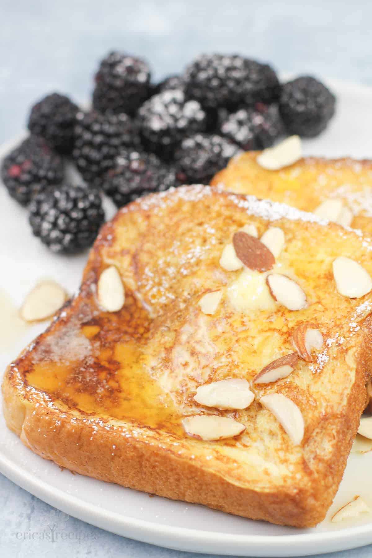 French toast with fresh blueberries on a plate.