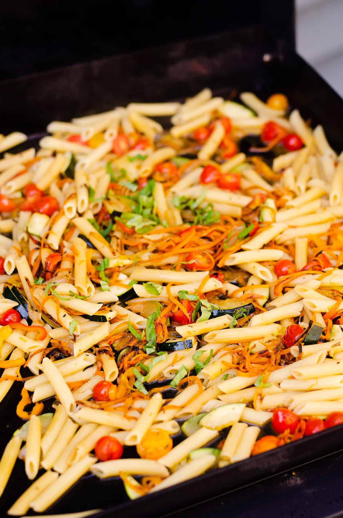Penne pasta and vegetable on a Blackstone griddle.