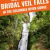 Traveler admiring the picturesque bridal veil falls surrounded by lush greenery in the columbia river gorge.