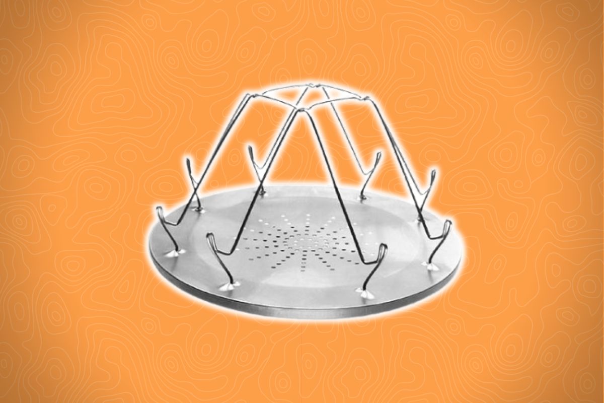 A round metal rack with eight upward-curving hooks and a perforated base on an orange background with wavy lines.
