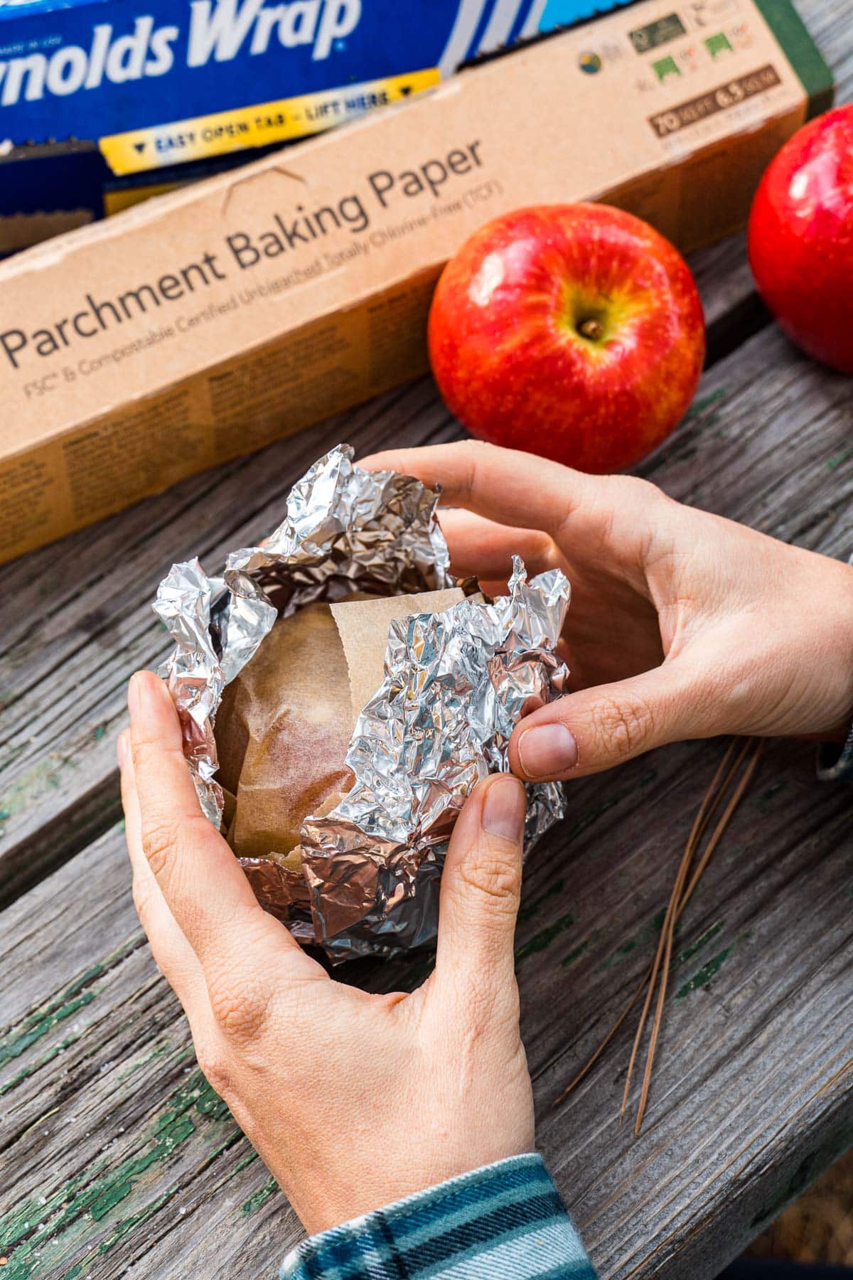 Wrapping an apple in foil.