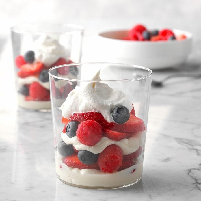 Cheesecake berry parfaits in a glass cup.
