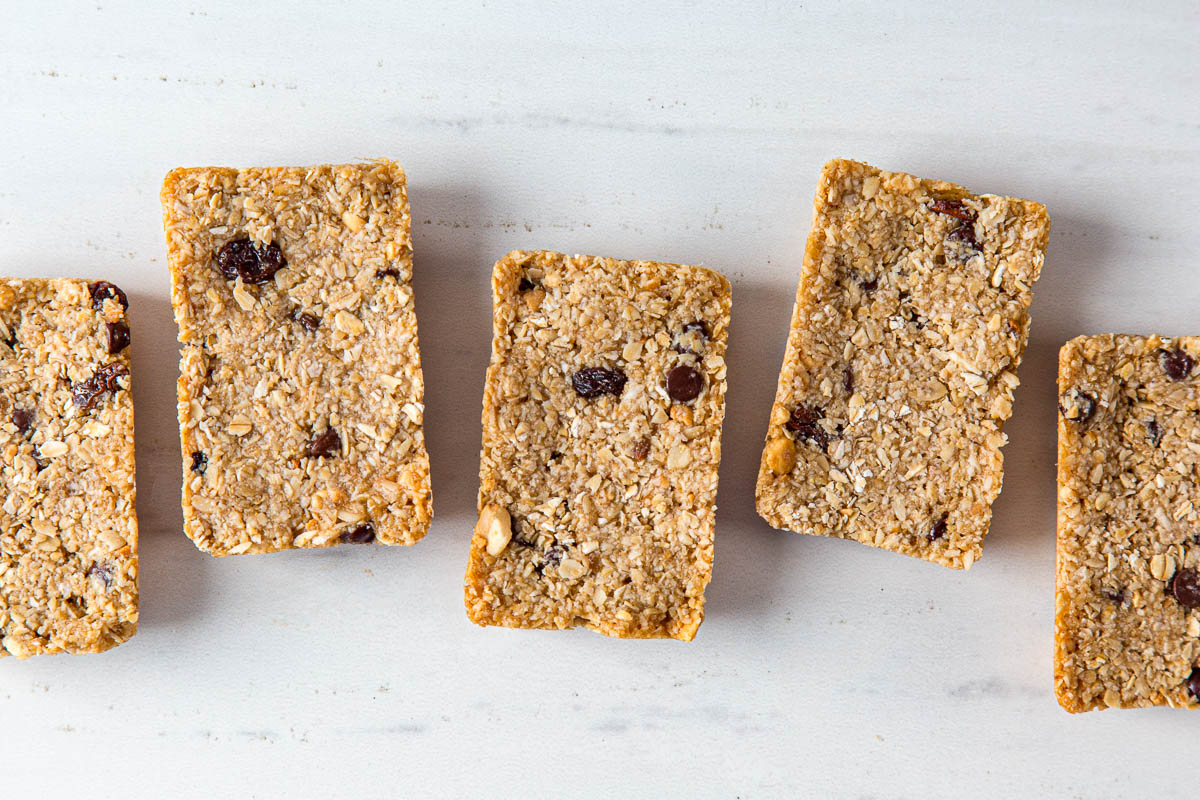 Five chewy granola bars on a marble countertop