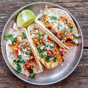 Three grilled chicken tacos on a plate
