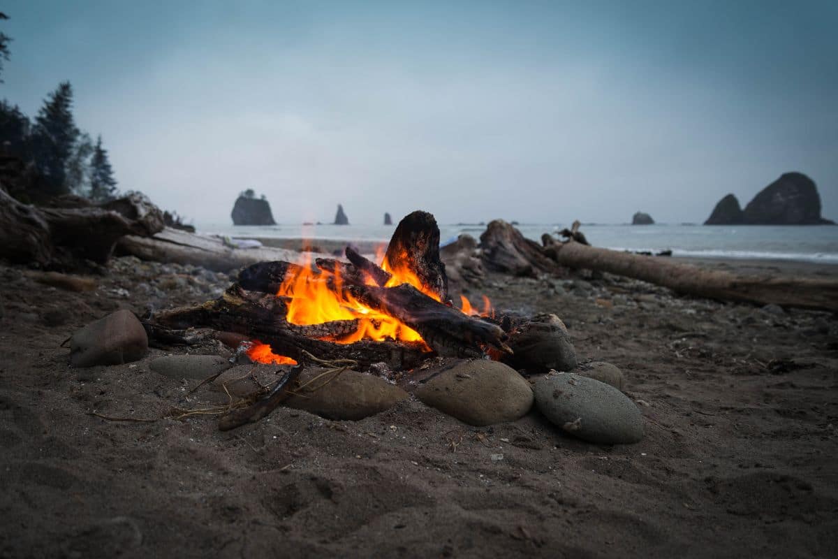 A campfire at an overcast beach