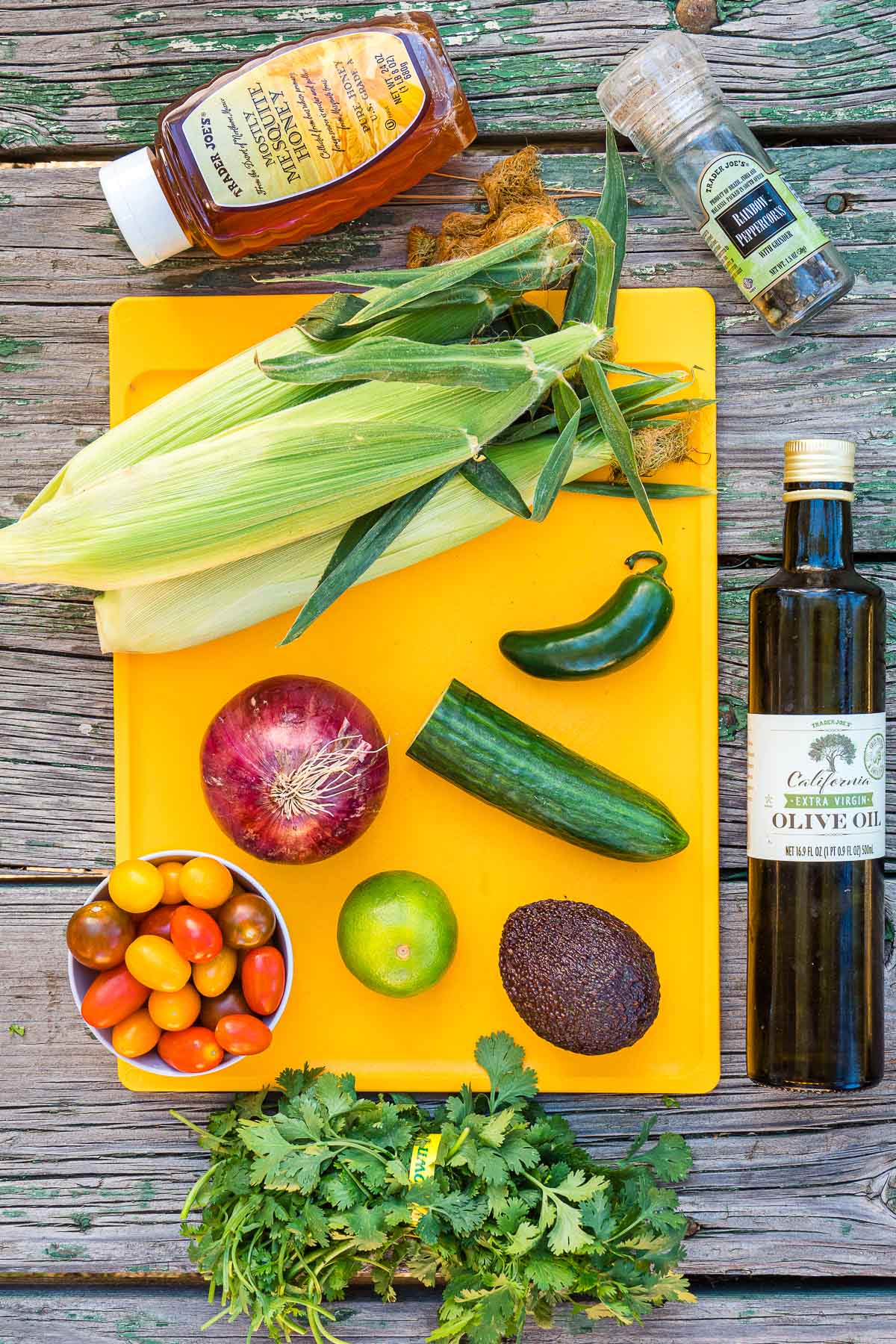 Ingredients for corn salad laid out on a cutting board