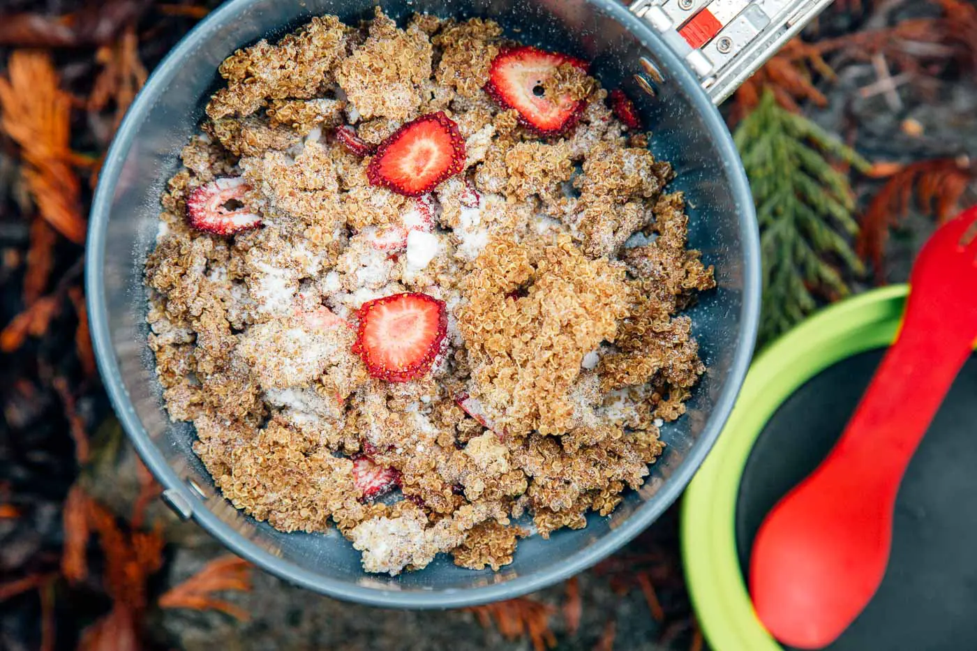 Strawberries and cream quinoa porridge in a backpacking pot