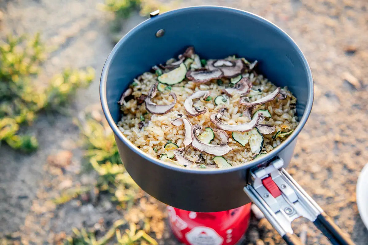 Dehydrated risotto in a pot on top of a backpacking stove