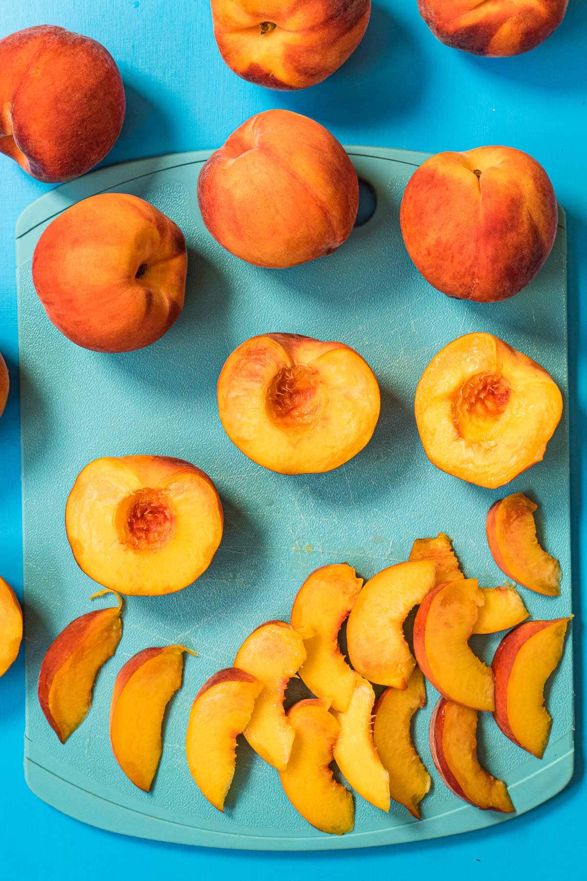 Peaches sliced on a cutting board