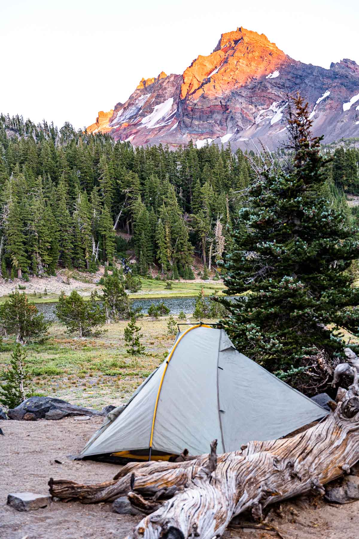 A backpacking tent with a mountain in the distance