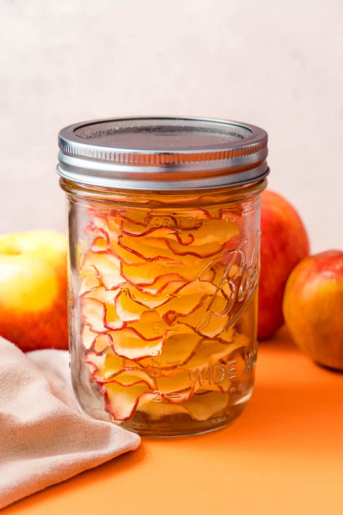 Apple chips stored in an airtight mason jar.