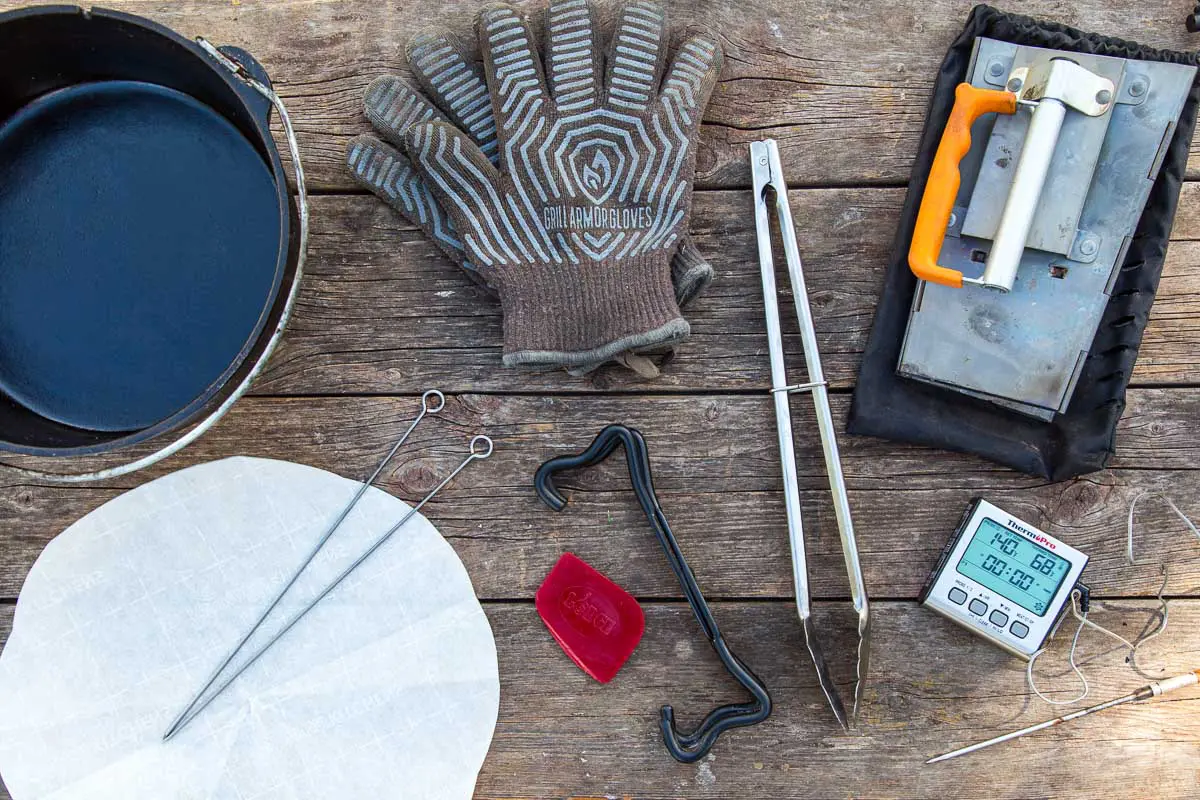 Dutch oven accessories laid out on a wooden surface