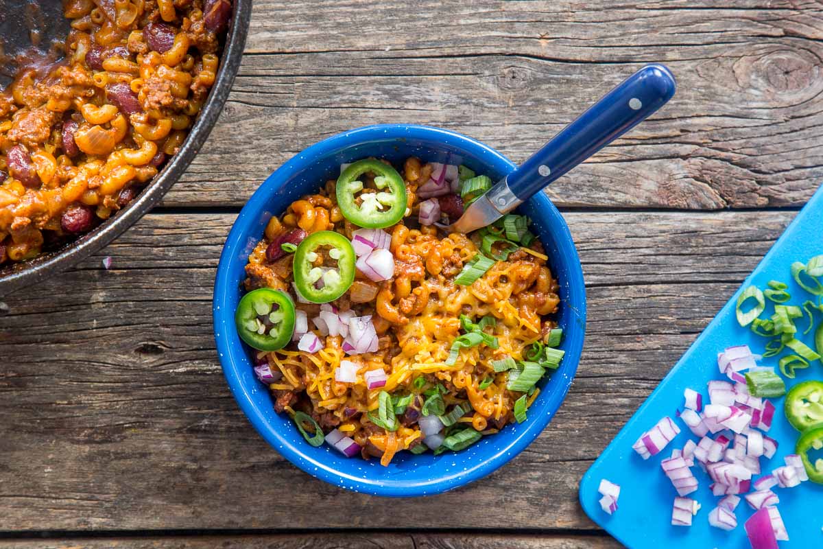 A bowl of chili mac on a camp table
