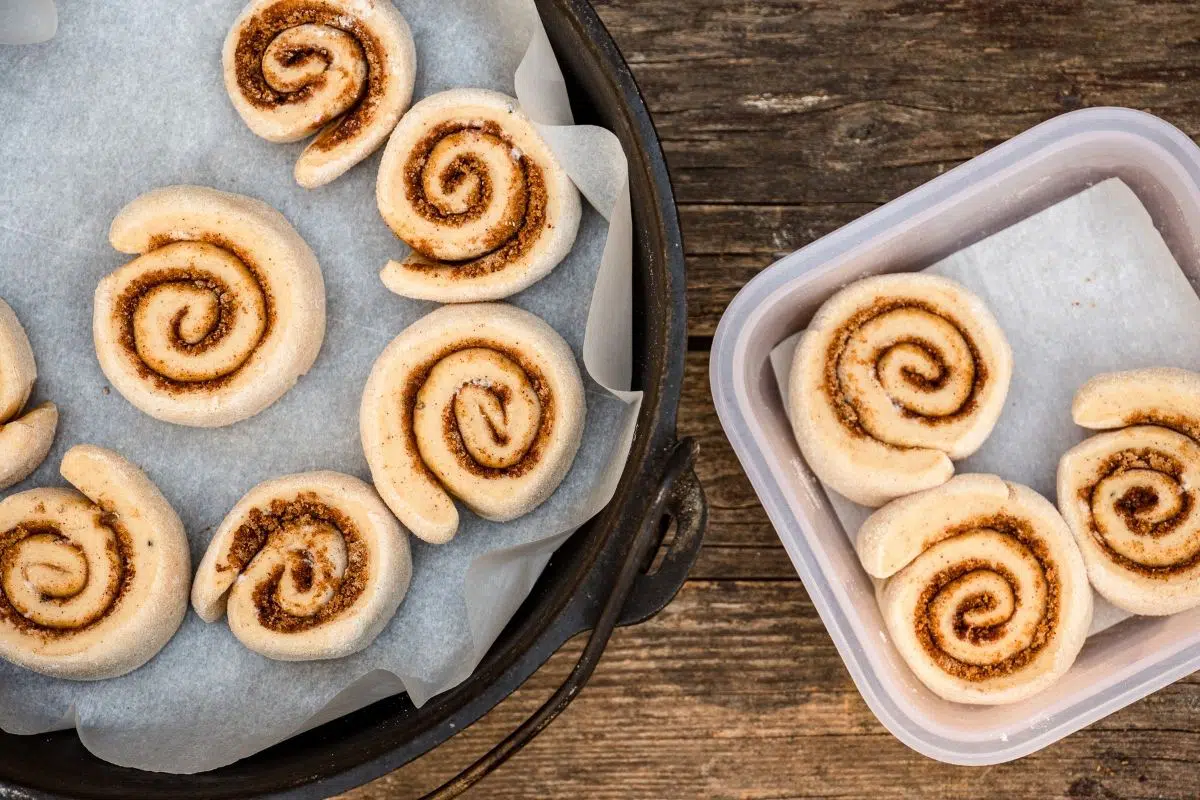 Transferring cinnamon rolls from a storage container into a dutch oven